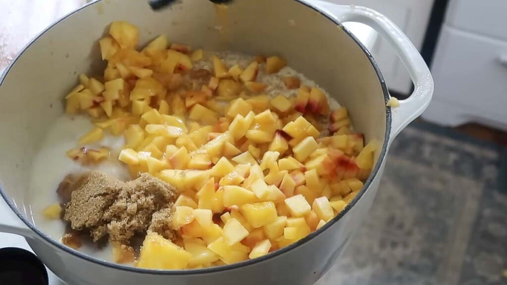 oats, brown sugar, milk, and peaches in a dutch oven