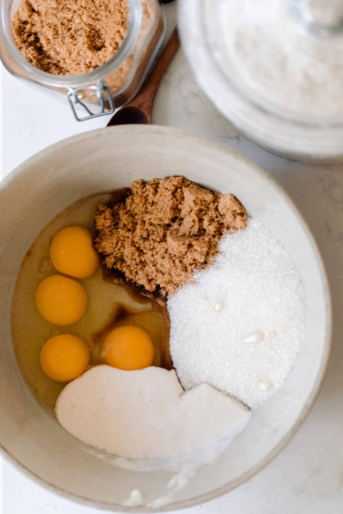 brown sugar, white sugar, oil, and sourdough starter in a bowl