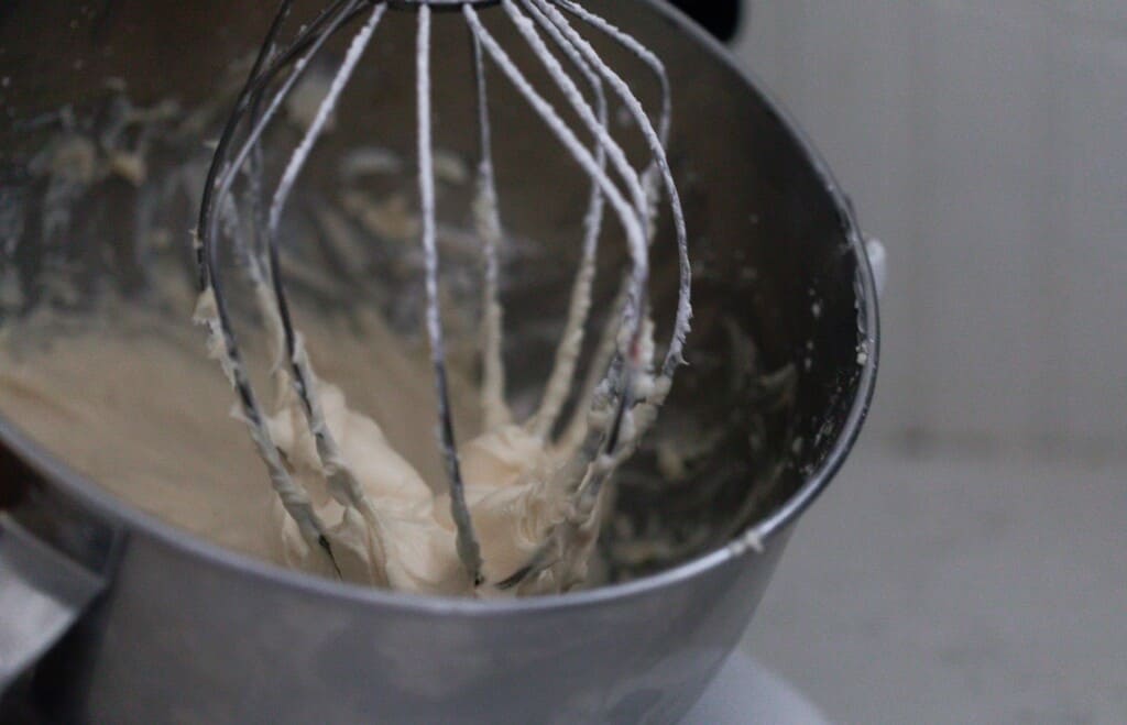 stand mixer with whisk attachment butter, cream cheese, and confectioners sugar