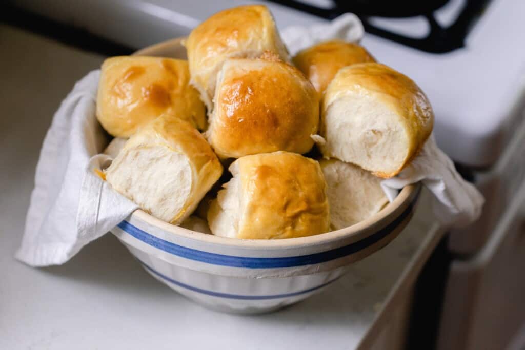 bowl of sourdough Hawaiian rolls on a white countertop