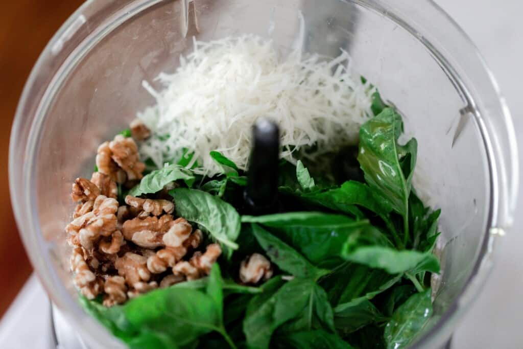 basil, parmesan, and walnuts in a food processor.