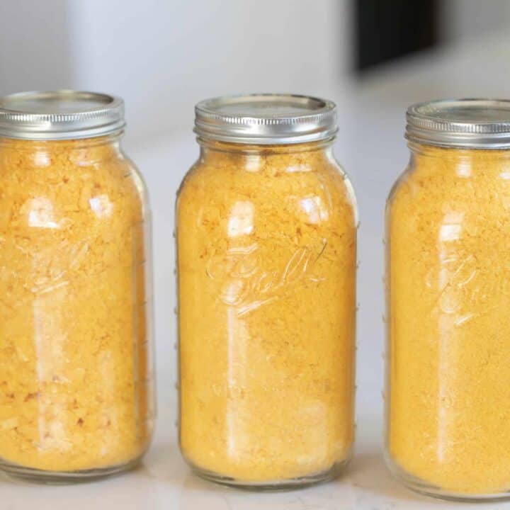 three half gallon mason jars filled with freeze dried eggs. The jars sit on a white countertop