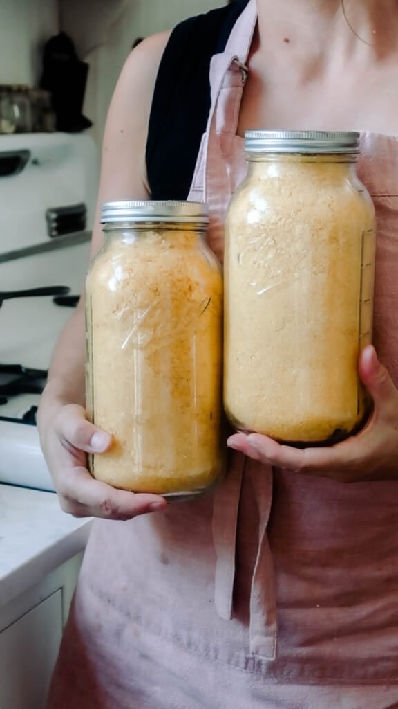 women holding two large jars of freeze dried eggs