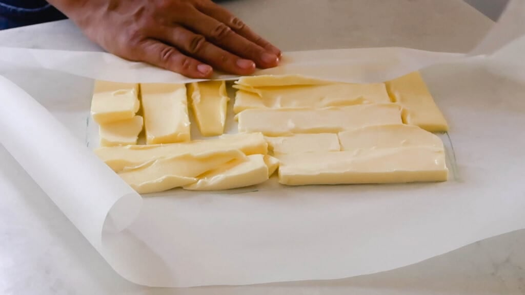 sticks of butter cut into 1/4 and placed into a rectangle on parchment paper