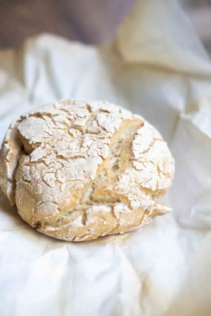 crusty gluten free sourdough bread placed on parchment paper