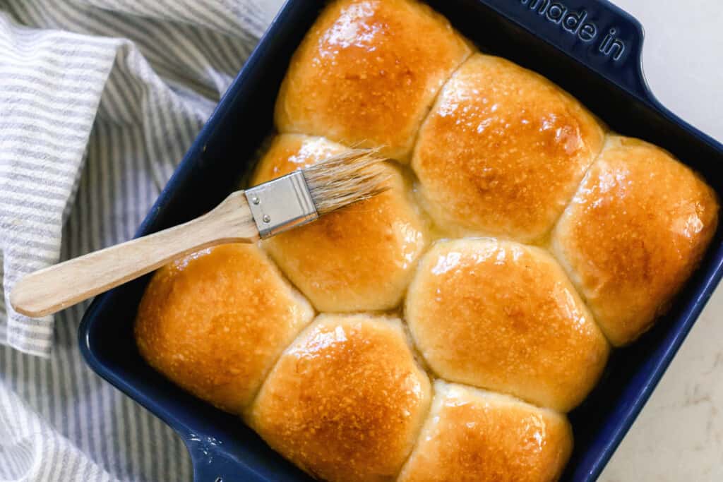 overhead photo of sourdough dinner rolls in a blue baking dish