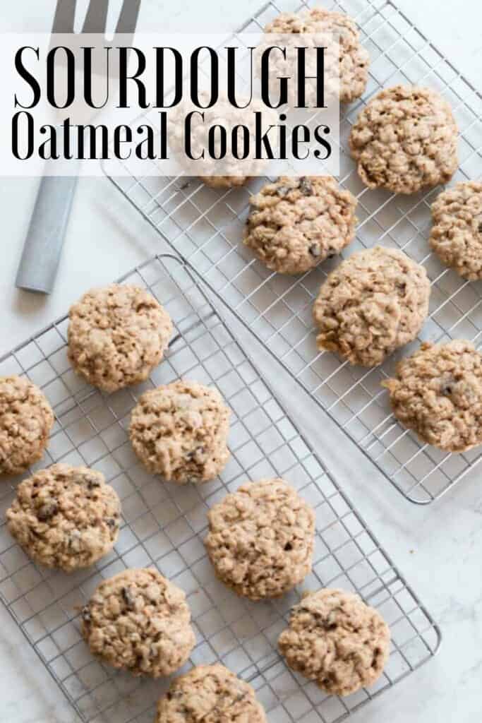 overhead photo of two wire racks full of oatmeal cookies on a white countertop with a metal spatula in the back corner