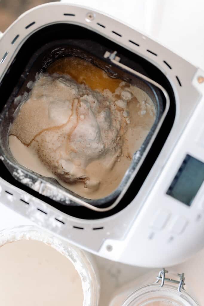 ingredients in a bread machine being kneaded together