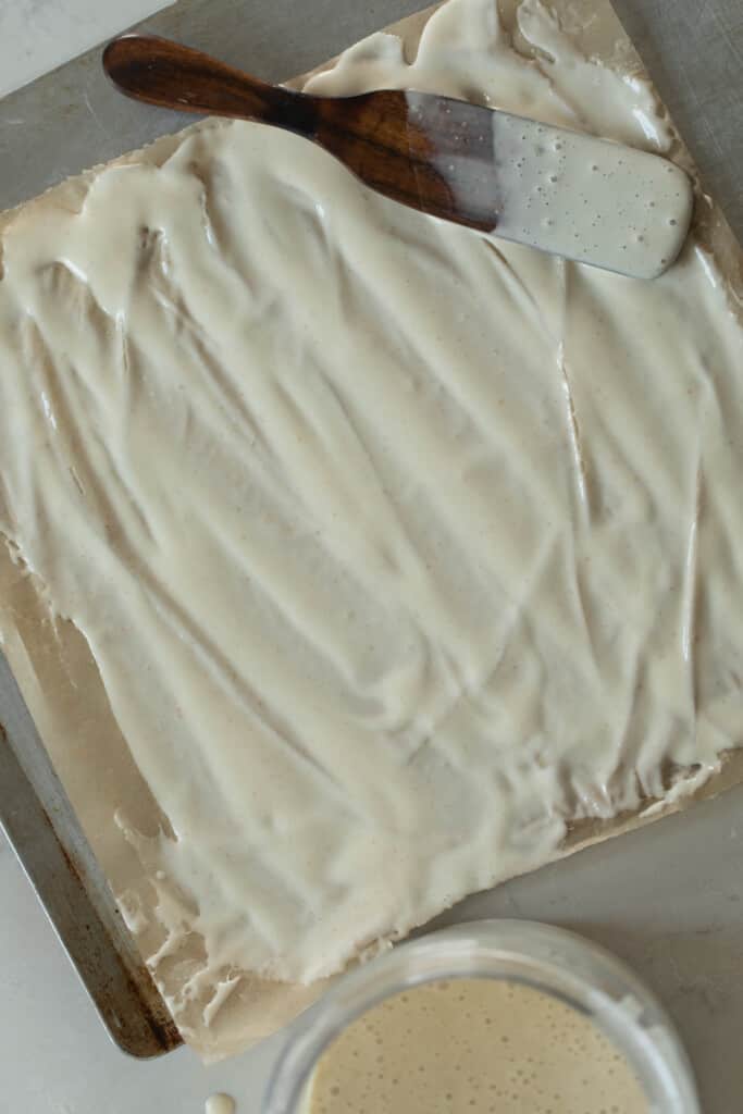 sourdough starter spread out on a silicon baking mat