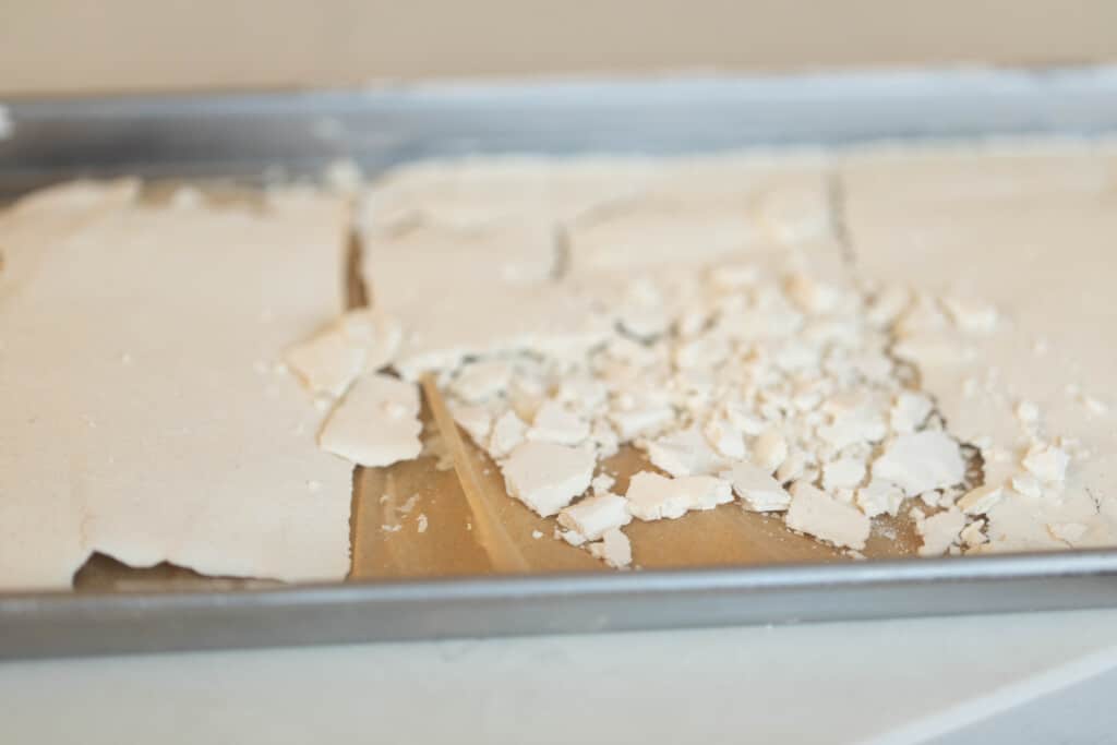 dried sourdough starter on a parchment lined baking sheet