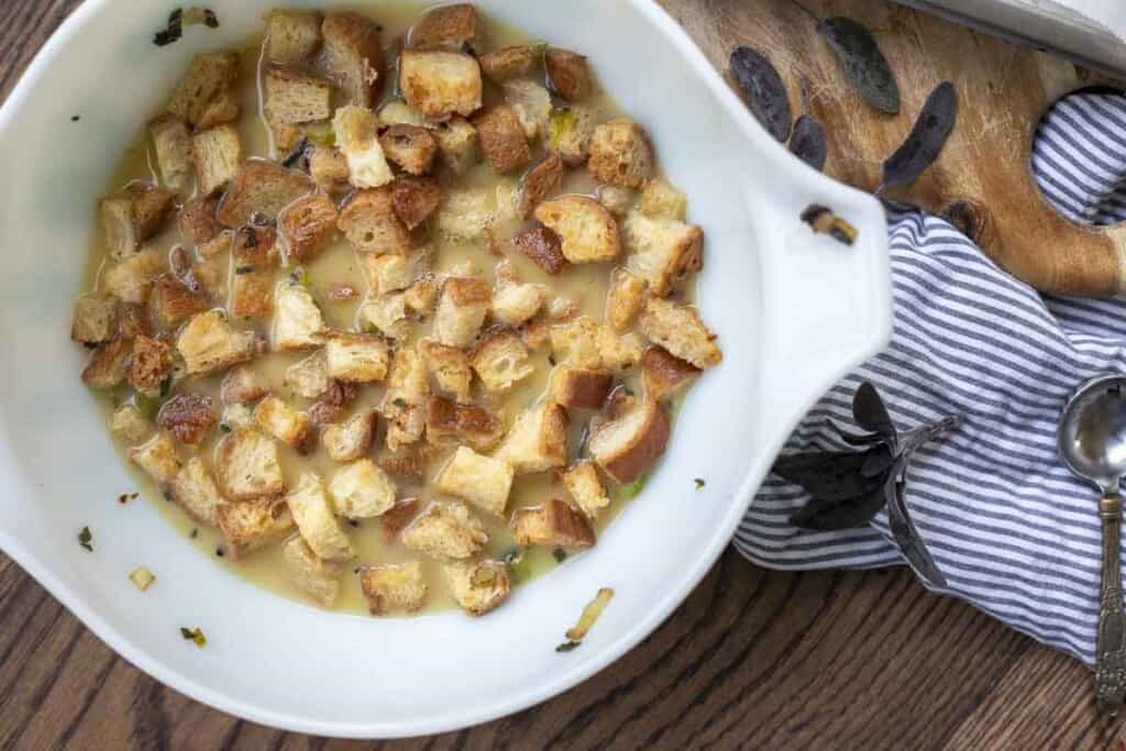 gluten free stuffing soaking in eggs and broth in a vintage pyrex bowl