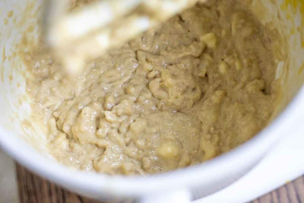 sourdough banana muffin batter in a white stand mixer bowl