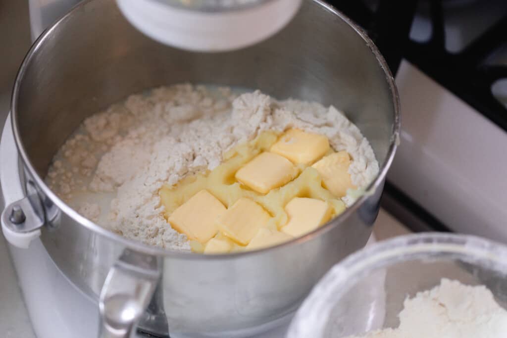 flour, butter, mashed potatoes, sourdough starter in a metal stand mixer bowl