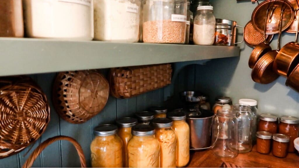 stocked pantry with glass jars full of flours