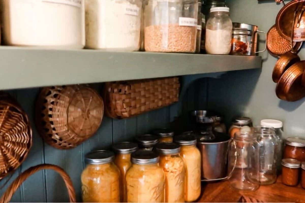 A pantry stocked full of jars.