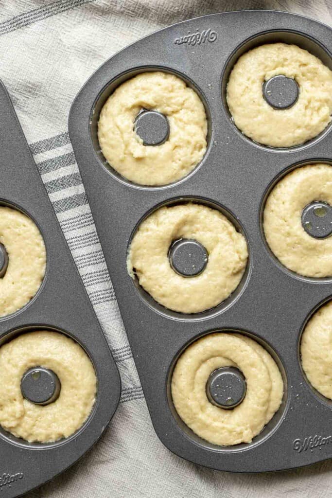 sourdough donut batter piped into donut pans