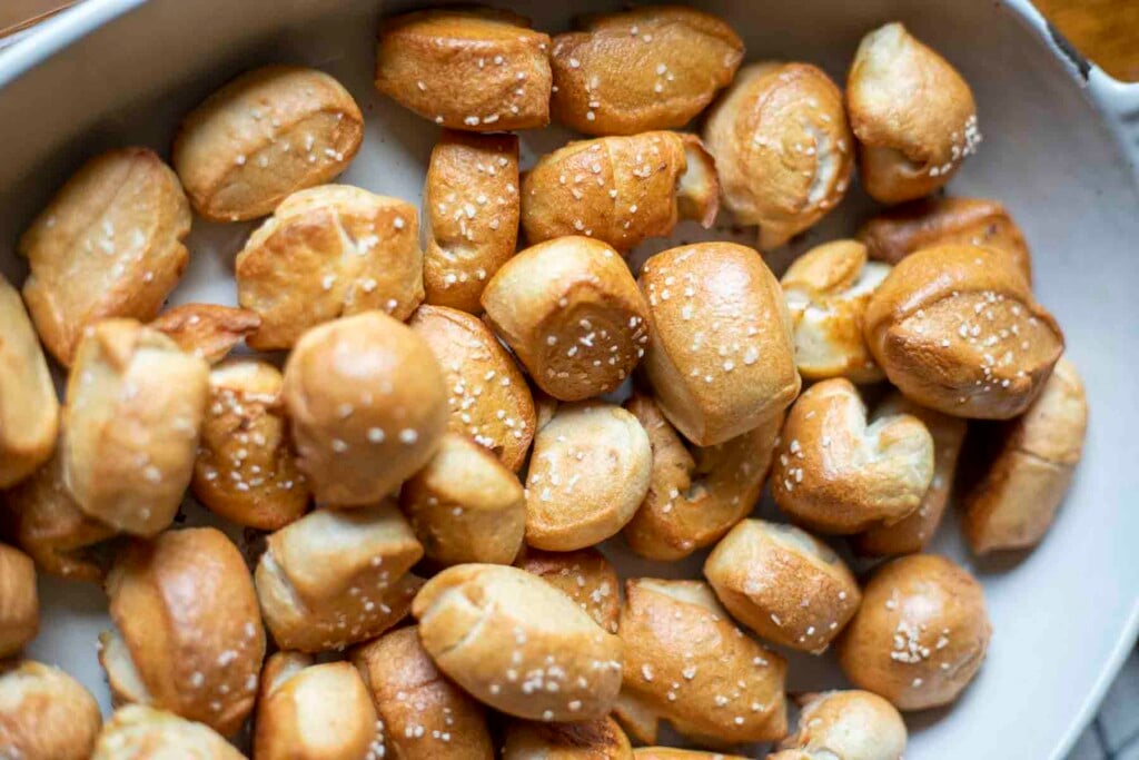 overhead photo of sourdough pretzel bites in a enameled cast iron dish