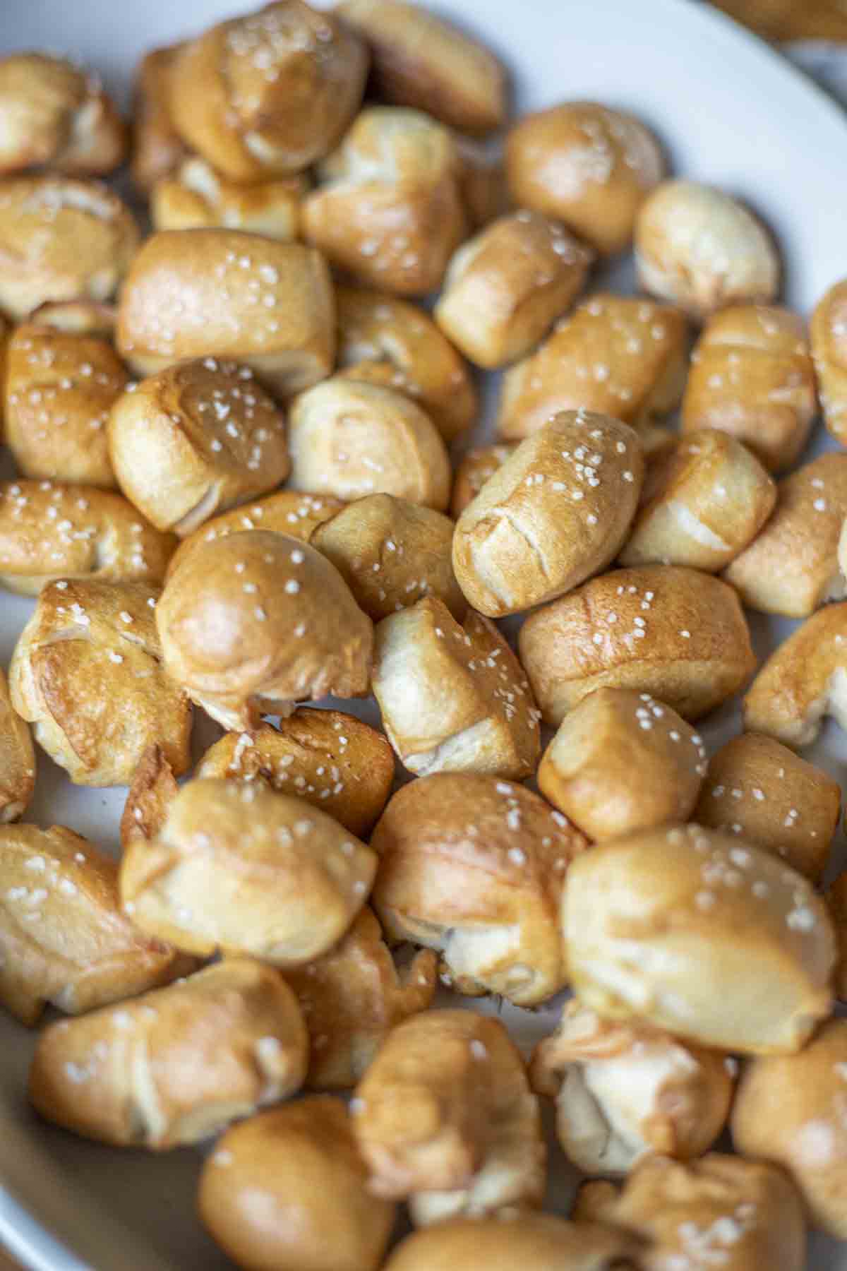 sourdough pretzel bites layered in a cast iron enameled pan