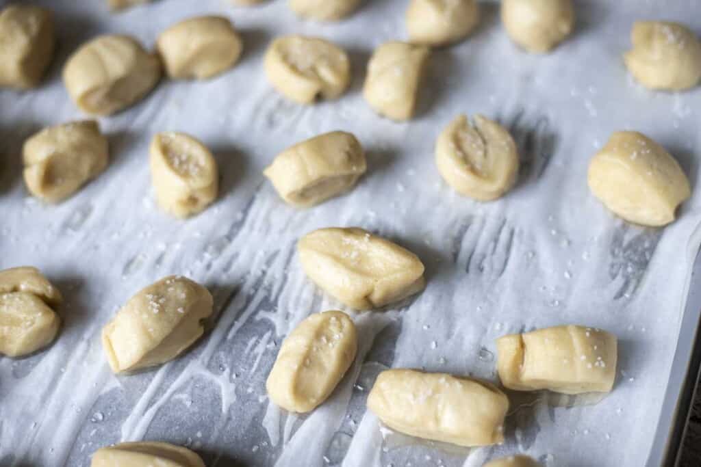 boiled potato dough sprinkled with salt and placed on a parchment lined baking sheet