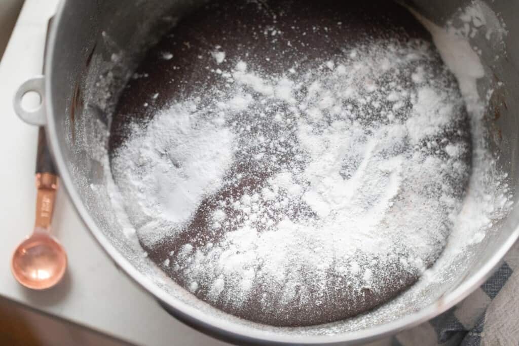 baking powder, baking soda, and salt added to the top of chocolate dough