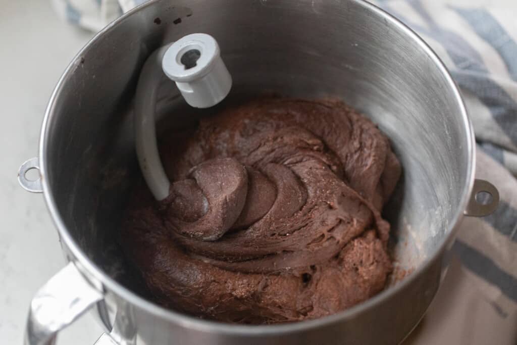 stand mixing bowl with chocolate dough with a dough hook in the dough