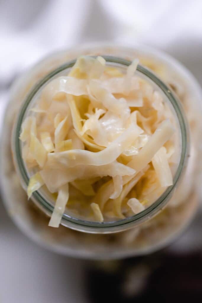 overhead photo of a jar full of homemade sauerkraut