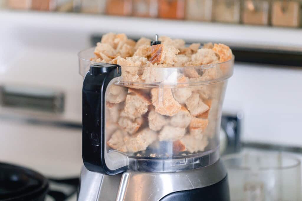 cubed bread in a food processor bowl