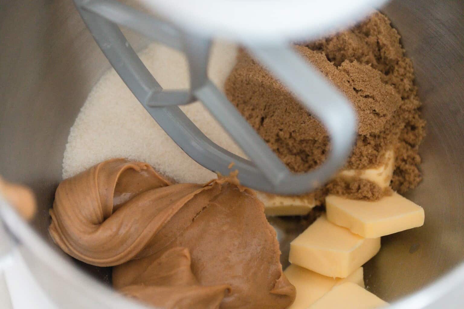 white sugar, brown sugar, butter, and peanut butter in a stand mixer bowl