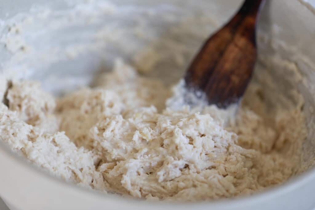 sourdough beer bread long fermentation adding ingredients with wooden spoon