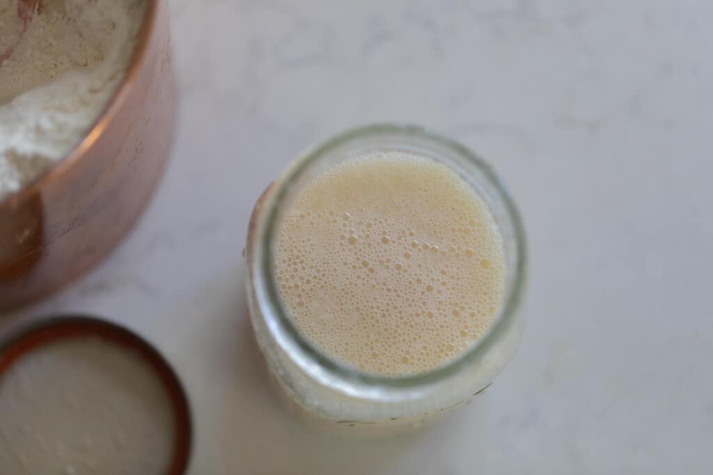 aerial view of a potato flake sourdough starter on a white counter top