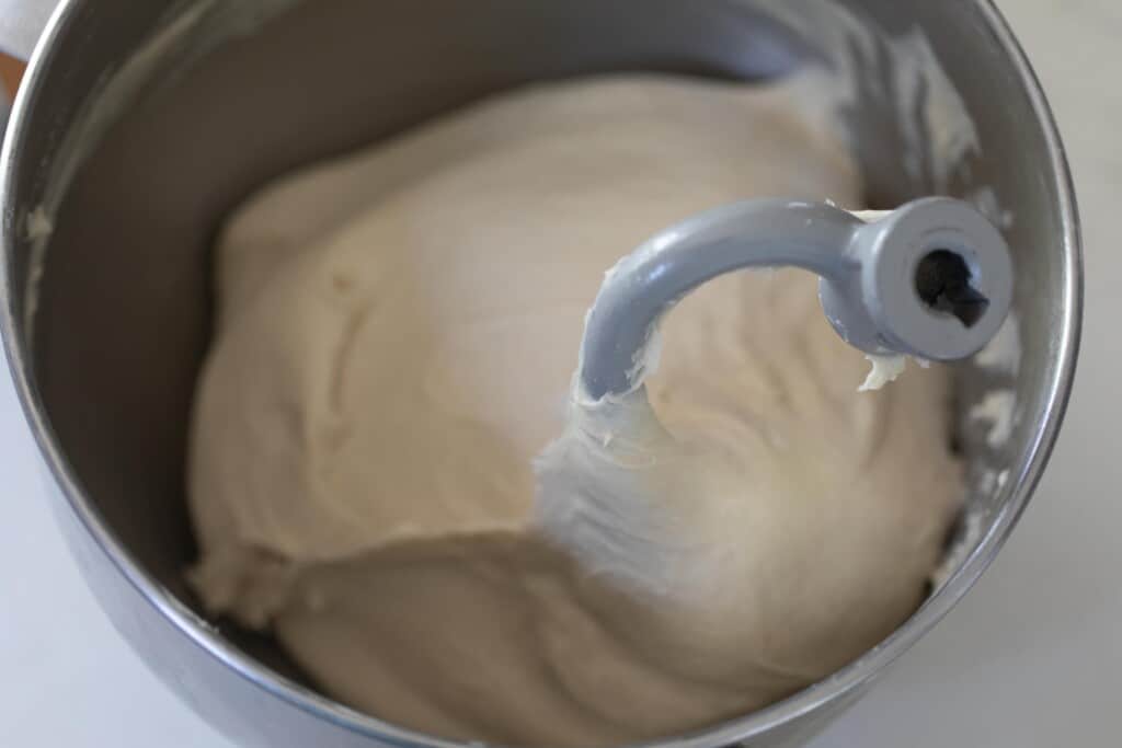 An aerial view of a stand mixer kneading dough for potato flake starter sourdough sandwich bread