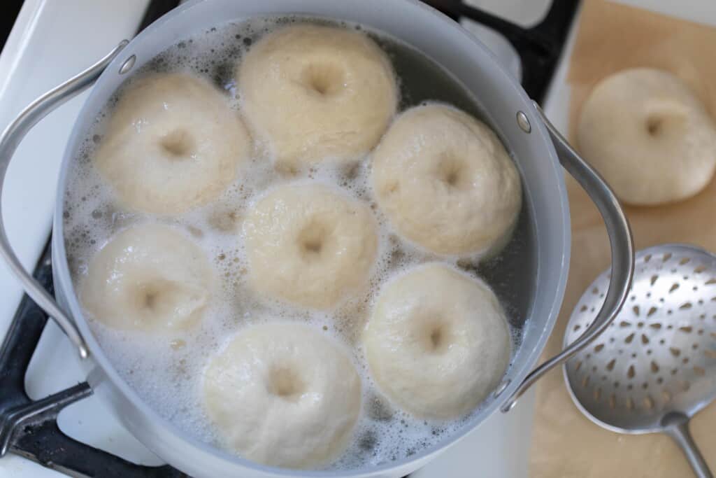 bagels boiling in a large pot