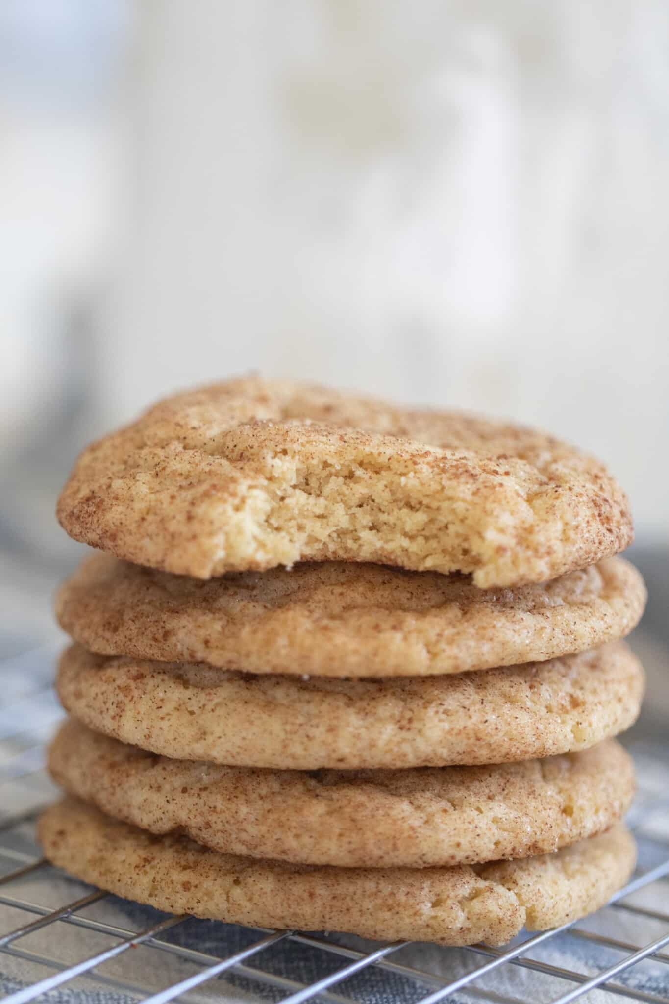 5 sourdough snickerdoodle stacked up on a wire rack