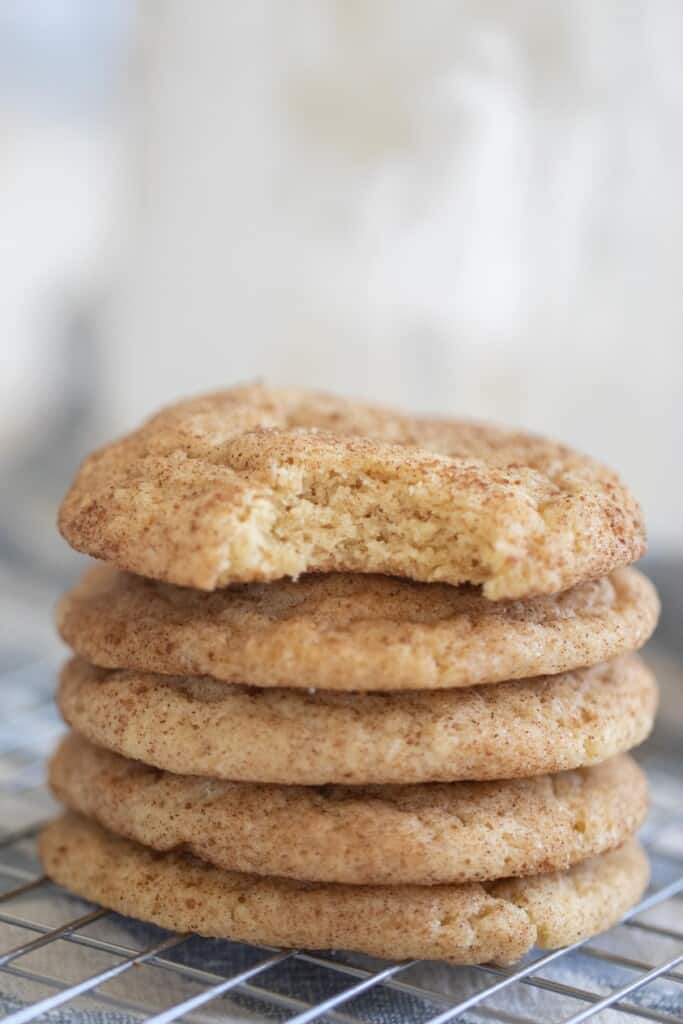 5 sourdough snickerdoodle stacked up on a wire rack