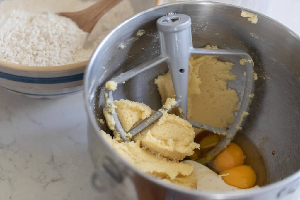 butter sugar and eggs in a stand mixer bowl with a paddle attachment 