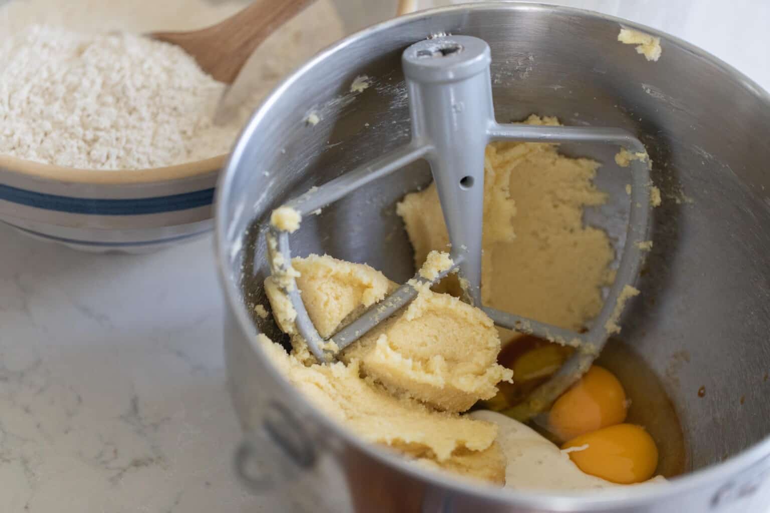 butter sugar and eggs in a stand mixer bowl with a paddle attachment