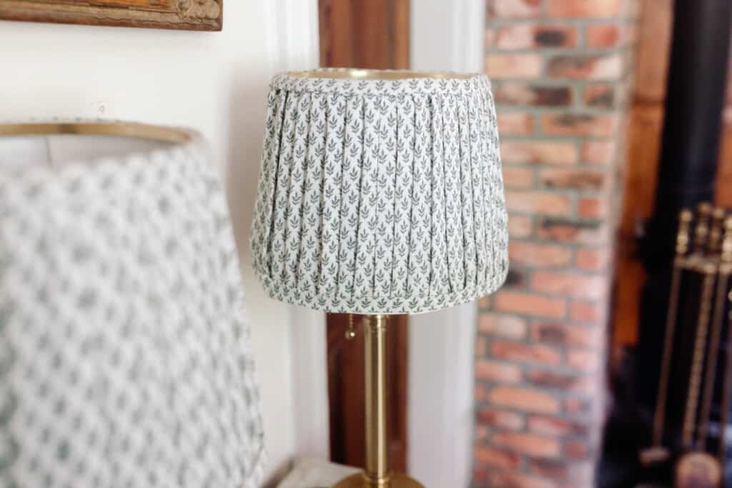 An angled view of two finished pleated lampshades