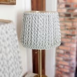 An angled view of two finished pleated lampshades