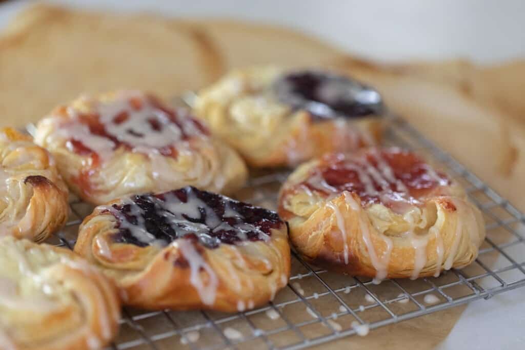 six sourdough Danish pastries with jam filling on parchment paper
