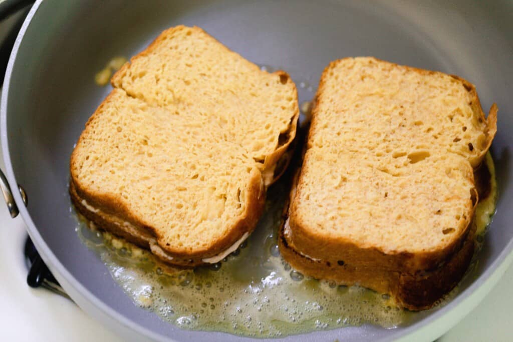 stuffed French toast cooking in butter in a skillet