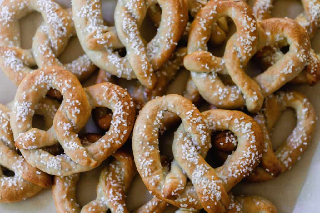 sourdough discard pretzels stacked in two layers on parchment paper