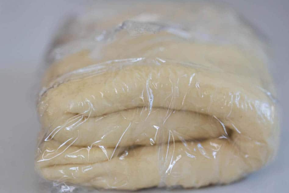 sourdough pastry braid dough folded up and wrapped in plastic wrap