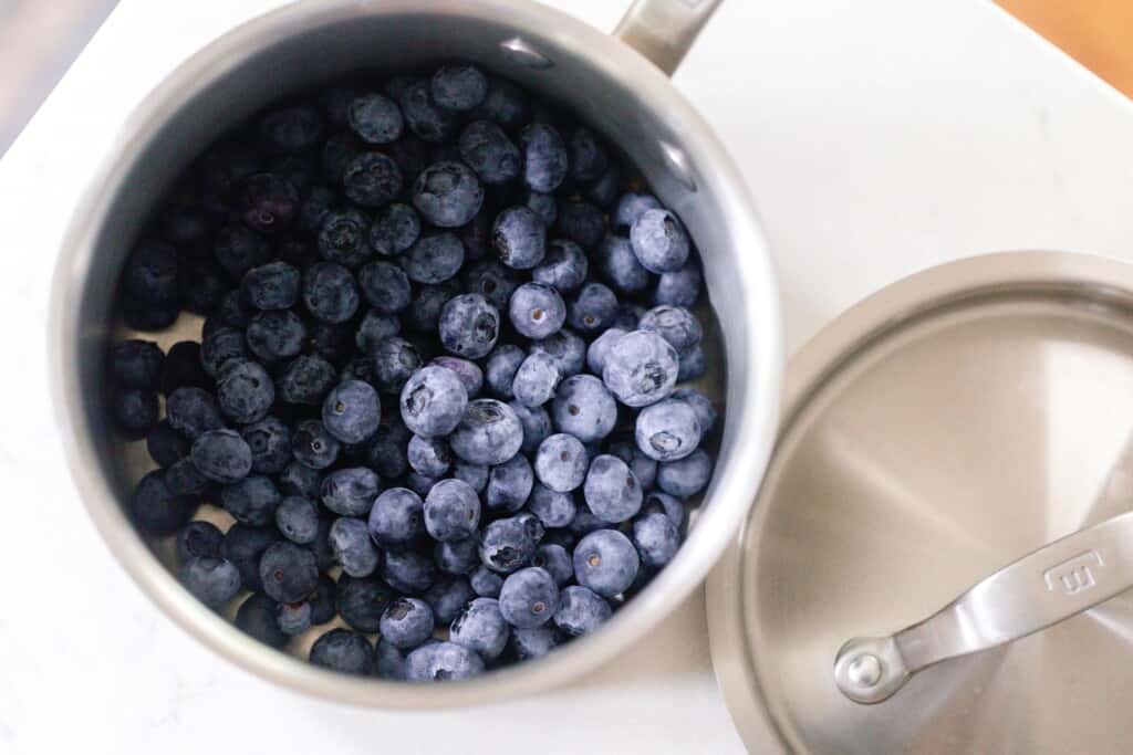 blueberries in a saucepan on a white countertop