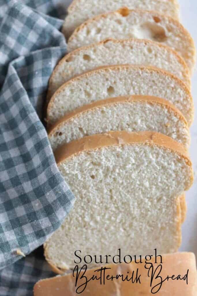 slices of sourdough buttermilk bread fanned out on a white and blue checked towel