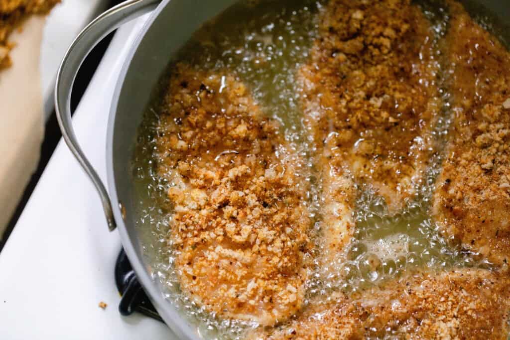 breaded chicken frying in lard