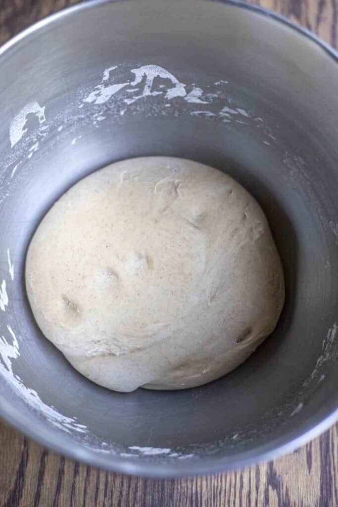 sourdough bagel dough in a stainless steel bowl
