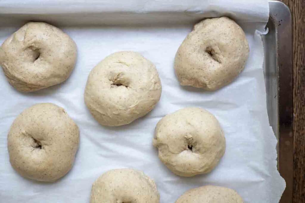 shaped bagels on a parchment lined bagels