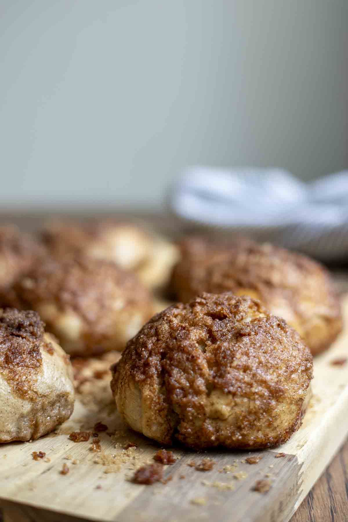 sourdough cinnamon crunch bagels on a wood cutting board