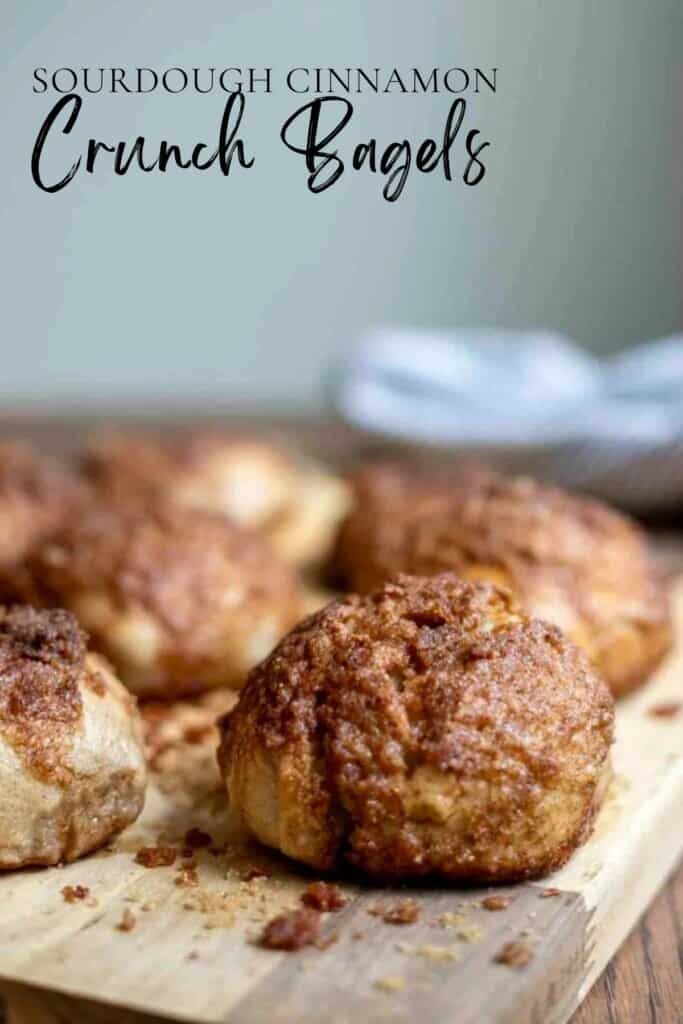 sourdough cinnamon crunch bagels on a wood cutting board