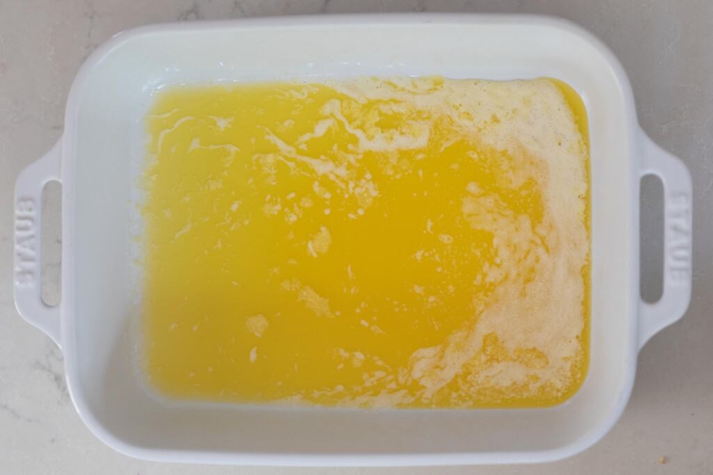 melted butter in a white baking dish